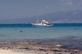 Boat at anchor, people snorkeling , Crete Greece