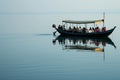 boat anchored with people dining on calm water