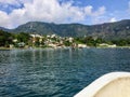 A boat approaching a small mayan village, San Juan La Laguna, on the beautiful clear waters of Lake Atitlan in Guatemala