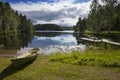 Boat on the bank of the forest lake. Finland Royalty Free Stock Photo