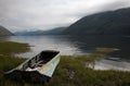 Boat on the bank of mountain lake Royalty Free Stock Photo