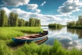 Boat on the bank of a river with green grass and blue sky