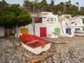 Boat at the beach, fishermen`s buildings Royalty Free Stock Photo