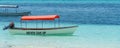 Boat at the beach on Zanzibar Island with the writing never give up with stunning turquoise water