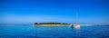 Boat and beautiful Fiji atoll island with white beach