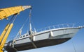 Boat being lifted by heavy crane machinery Royalty Free Stock Photo