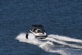 the boat is being pulled by the water skier in the middle of the ocean Royalty Free Stock Photo