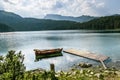 Boat on Black Lake in the national park Durmitor and mountains i Royalty Free Stock Photo