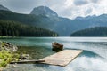 Boat on Black Lake in the national park Durmitor and mountains i Royalty Free Stock Photo