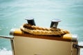 Boat bollard with rope against water background Royalty Free Stock Photo