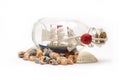 Boat in the bottle and sea shells on white background