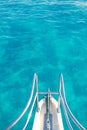 Boat bow in transparent turquoise water Royalty Free Stock Photo