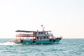 A boat brings tourists to an island in the sea in Thailand