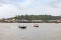 boat and building along Sungai Kedayan river, the capital of Brunei Darussalam in sunny day with white coulds and blue sky Royalty Free Stock Photo