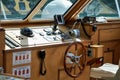 Boat cabin interior featuring a steering wheel and open windows