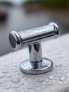 Boat cleat with raindrops on a wet surface. Royalty Free Stock Photo