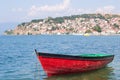Boat with coast town in background Royalty Free Stock Photo
