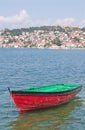 Boat with coast town in background Royalty Free Stock Photo