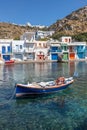 Boat Coloured houses in Klima beach with Trypiti village in background