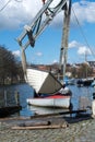 Boat crane lifts the boat into the water