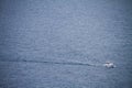 Boat crossing the sea with wake