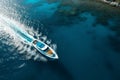 boat cruising anchoring in high speed open blue sea Drone view Royalty Free Stock Photo