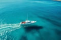 boat cruising anchoring in high speed open blue sea Drone view Royalty Free Stock Photo