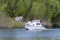 Boat Cruising on River Yare, Norfolk Broads, Surlingham, Norfolk, England, UK Royalty Free Stock Photo