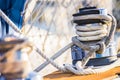 Boat deck of sailing yacht with close-up of moored nautical rope at winch Royalty Free Stock Photo