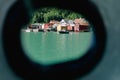 A boat doccked at the small port in little town in Norway, view thorugh ship window Royalty Free Stock Photo