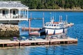 Boat at Dock with Colorful Picnic Tables Royalty Free Stock Photo