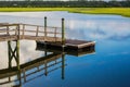 Boat Dock reflecting in inlet marsh water