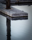 Boat dock reflection in calm water Royalty Free Stock Photo