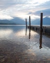 Boat Dock with Reflection in Lake McDonald in Glacier National Park, Montana, at Dawn Royalty Free Stock Photo