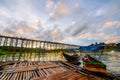 A boat dock for a river tour, built in a bamboo raft near an ancient wooden bridge in Sangkhlaburi District Royalty Free Stock Photo