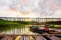 A boat dock for a river tour, built in a bamboo raft near an ancient wooden bridge in Sangkhlaburi District Royalty Free Stock Photo