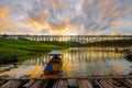 A boat dock for a river tour, built in a bamboo raft near an ancient wooden bridge in Sangkhlaburi District Royalty Free Stock Photo