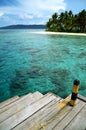 A boat dock and tropical beach Royalty Free Stock Photo