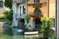 Boat docked near old medieval house in Como town, Lake Como, Italy Royalty Free Stock Photo