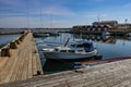 Boat docked at old wooden harbour Royalty Free Stock Photo