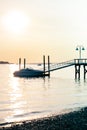 Boat docked on water with bright sunset background portrait Royalty Free Stock Photo