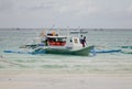 A boat docking on beach in Boracay, Philippines