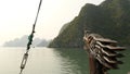 A boat with a dragon`s head floating in the ocean. Vietnam. Ha Long Bay. Royalty Free Stock Photo