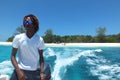 Boat driver man in dark glasses going from beach to the sea Seychelles islands
