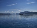 Boat driving across a deep blue lake in the scottish highlands Royalty Free Stock Photo