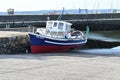 Boat on dry land due to a severe drought and the receding tide