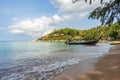 Boat on empty calm sandy tropical Sairee beach in the morning on Koh Tao island in Thailand. Picturesque peaceful calm shore with