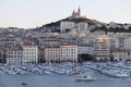 Boat enetering Vieux-Port with Basilique Notre Dame de la Garde on the hill in the background, Marseille, Bouches-du-Rhone, Royalty Free Stock Photo