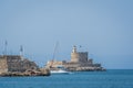 Boat entering historic Mandraki port in Rhodes, Greece