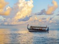 Boat of exotic shape at sunset in the Indian ocean Royalty Free Stock Photo